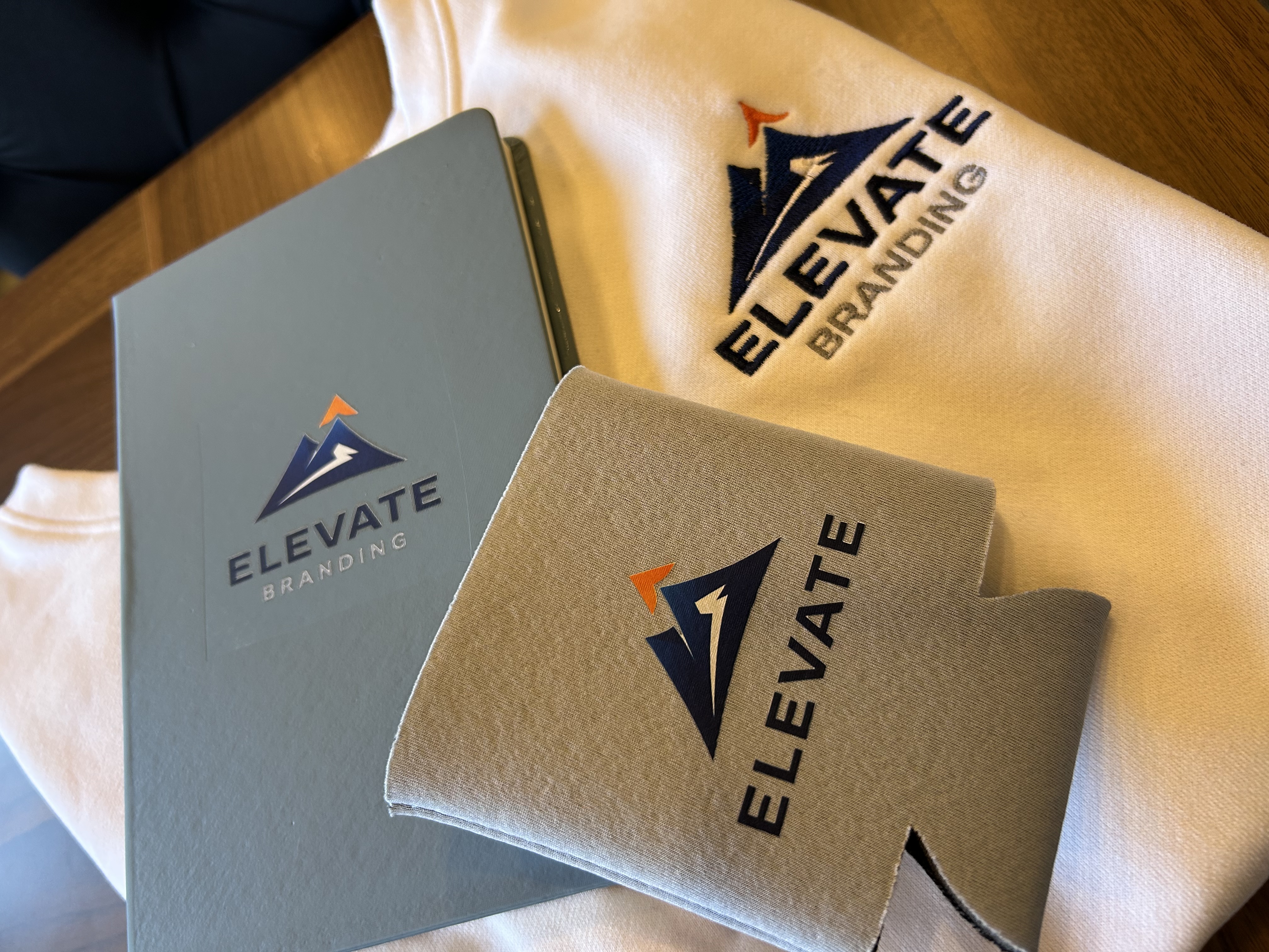 Business Starter Bundle with embroidered sweatshirt, koozie, and notebook with Elevate Branding logo